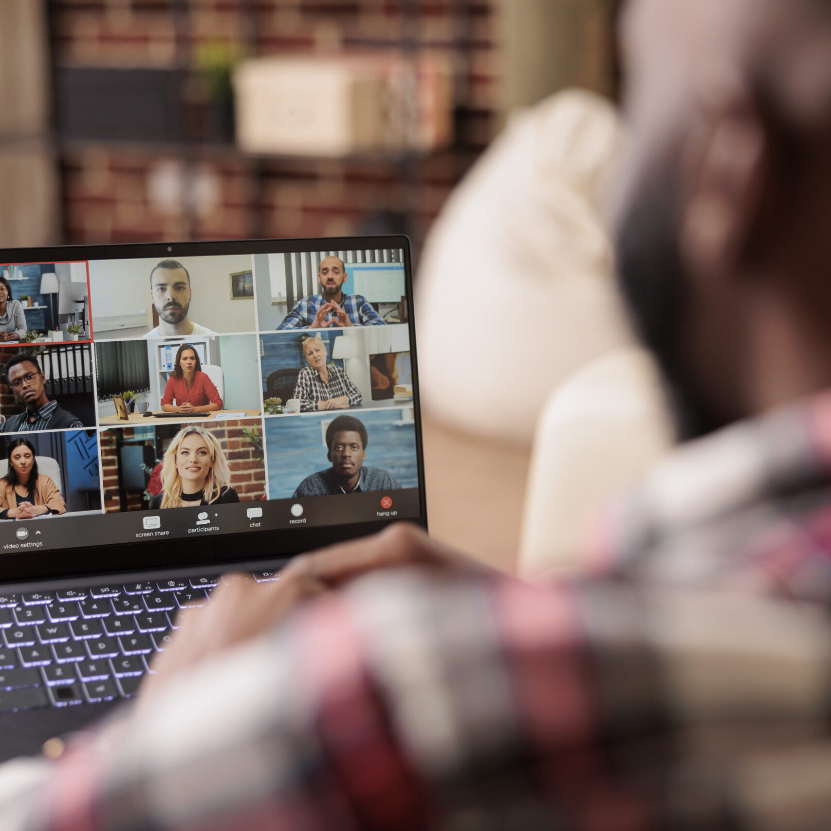 African american man talking on videocall online meeting, attending videoconference with business people. Chatting on remote teleconference with colleagues, using webcam on laptop at home.